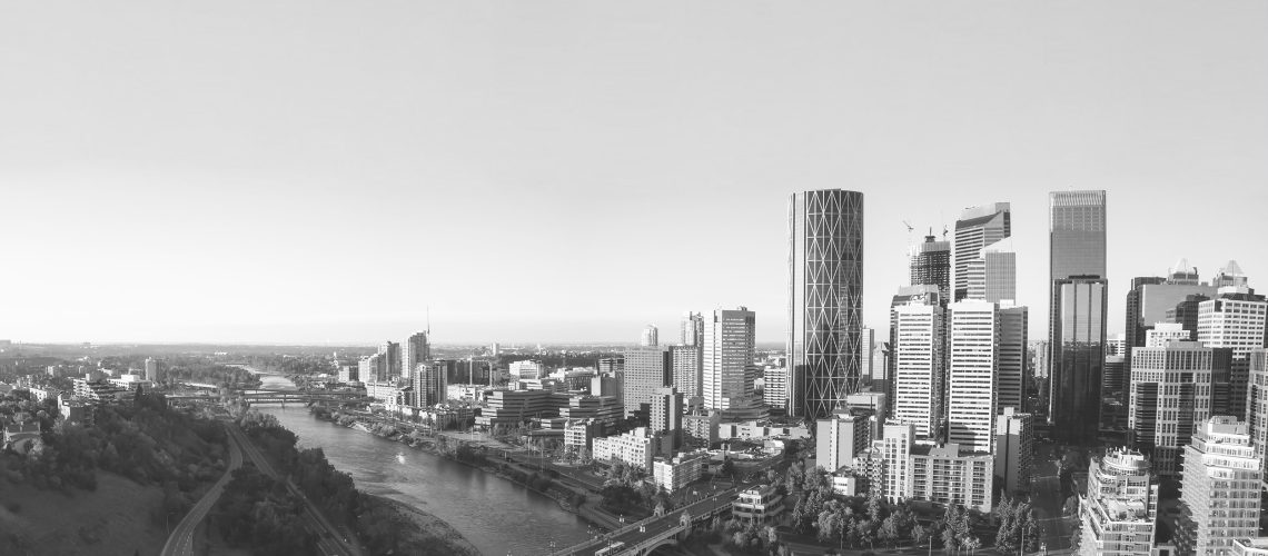 Aerial panoramic view of a beautiful modern cityscape during a vibrant sunny sunrise. Taken in Calgary Downtown, Alberta, Canada.